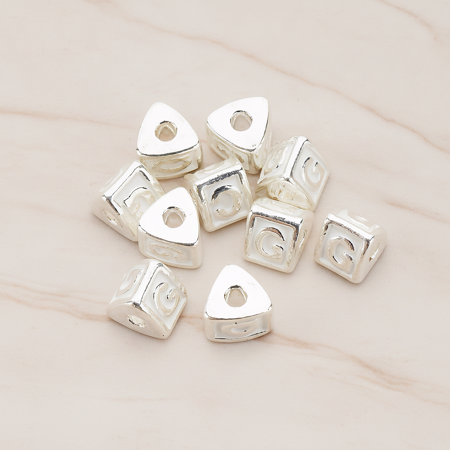 Triangle Cube Initial Metal Bead, 2 Pc on warm marble background (PD.1136)