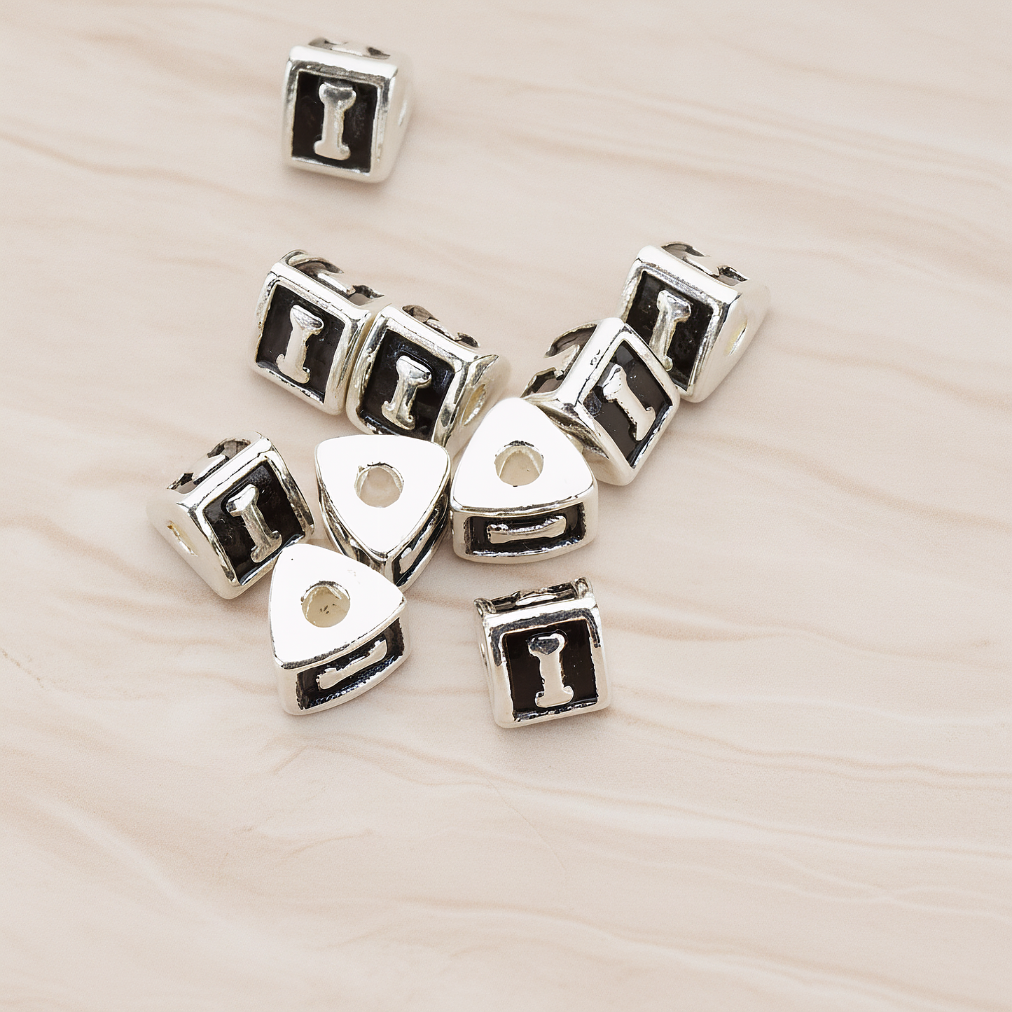 Triangle Cube Initial Metal Bead, 2 Pc on warm marble background (PD.1136)