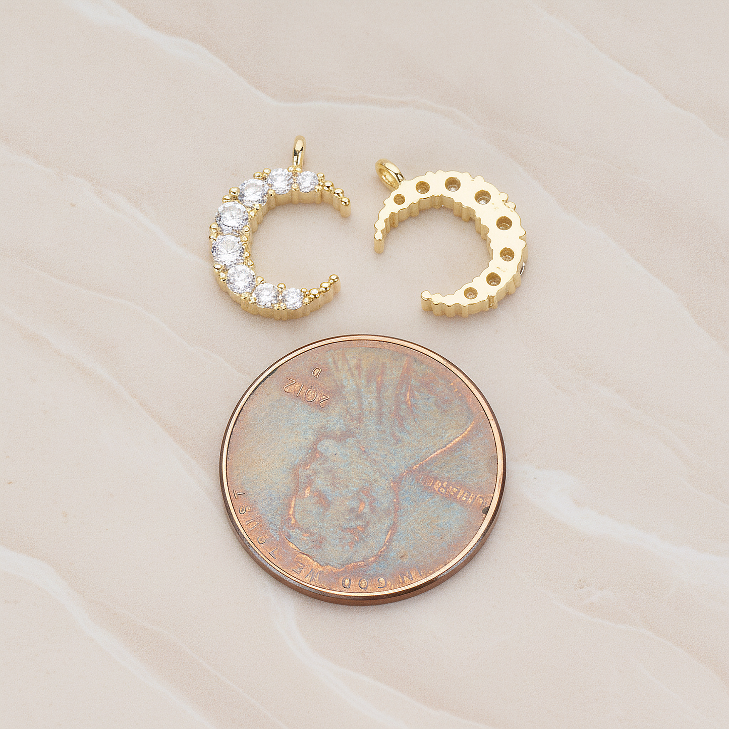 Round Crystal Cut Cubic Zirconia Crescent Moon Pendant, 2 Pc on warm marble background (PD.1174)