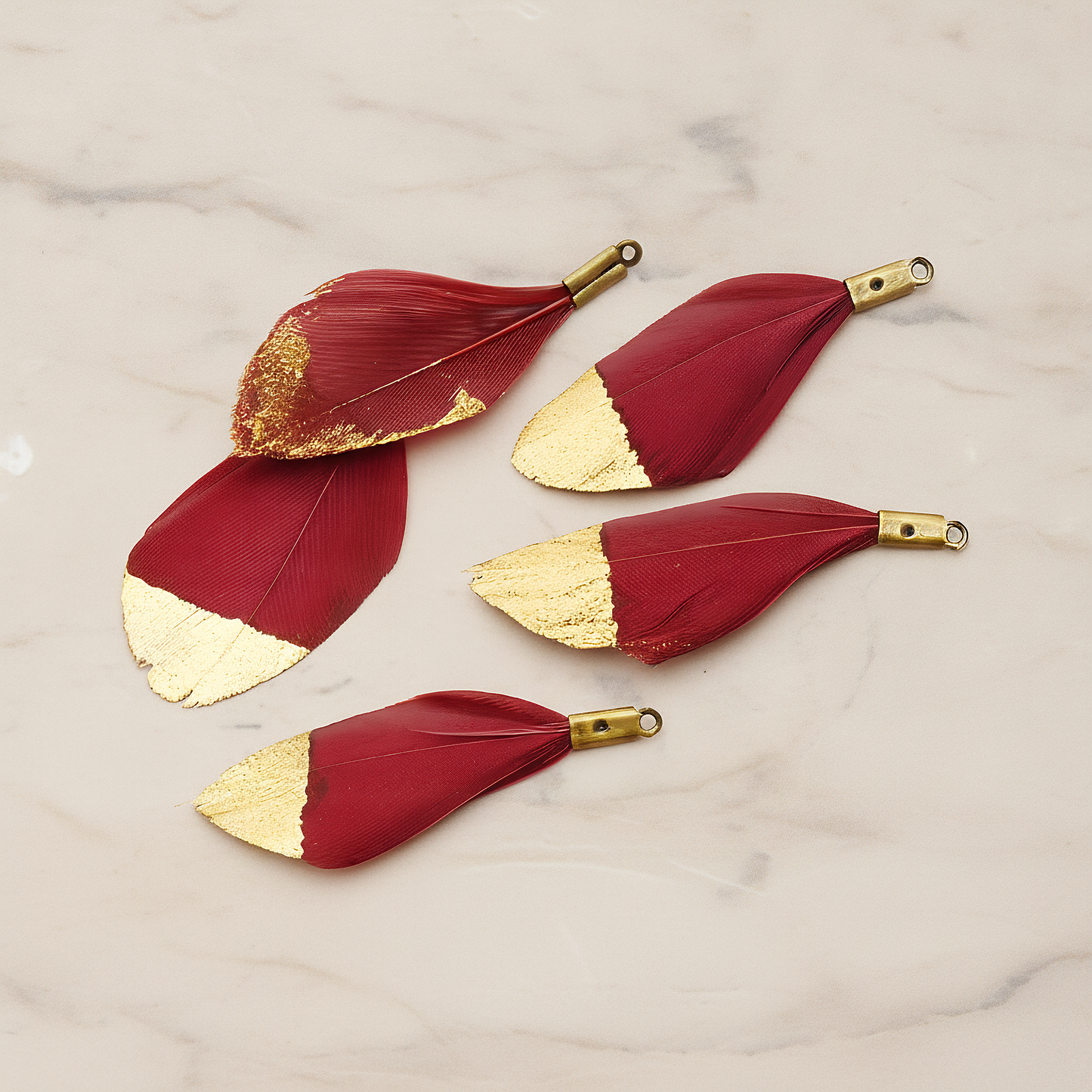 Small Artificiality Feather Half Dipped in Gold Colored Pendant, 2 Pc on warm marble background (PD.1492-05)