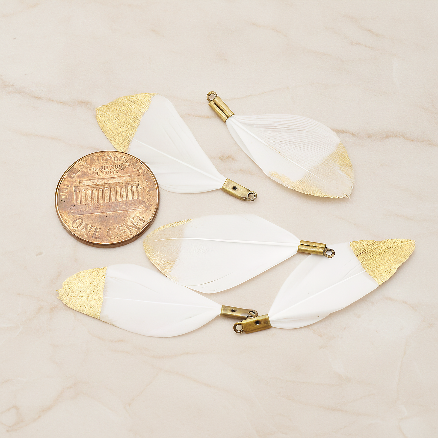 Small Artificiality Feather Half Dipped in Gold Colored Pendant, 2 Pc on warm marble background (PD.1492-05)
