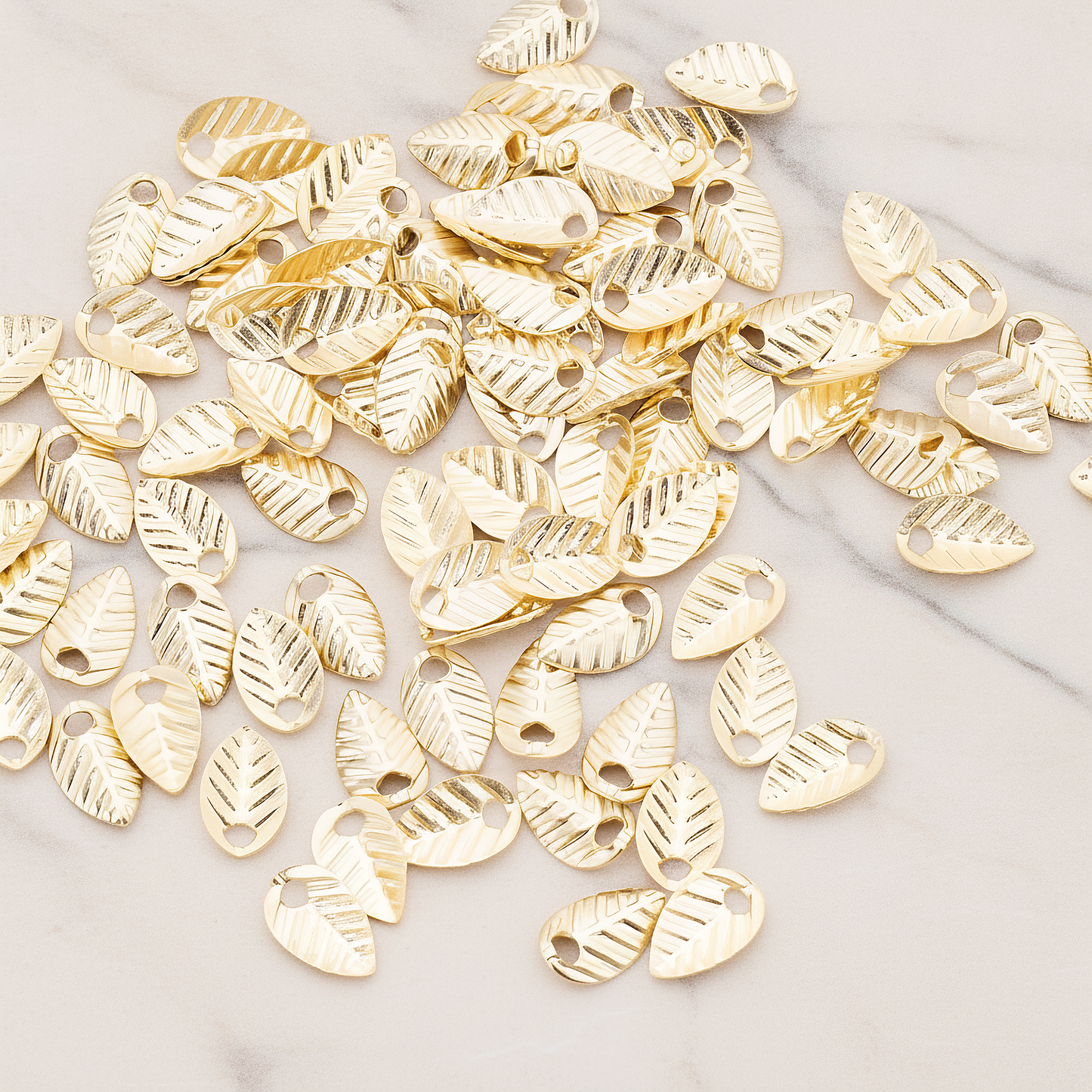 Half Fold Tiny Leaf Charm, 20 Pc on warm marble background (PD.222)