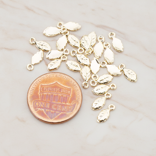 Xsmall Tiny Leaf Charm Pendant, 8 Pc on warm marble background (PD.388)