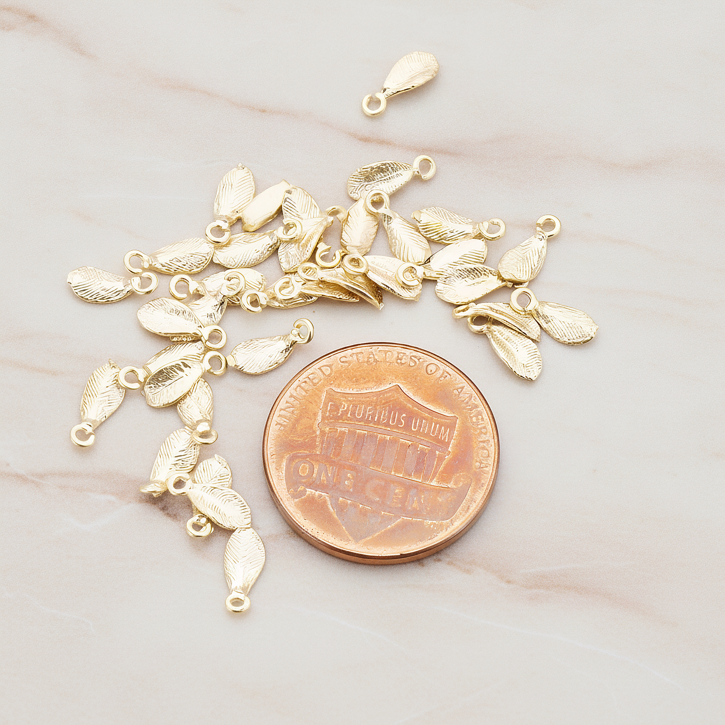 Tiny Leaf Charm Pendant, 8 Pc on warm marble background (PD.426)