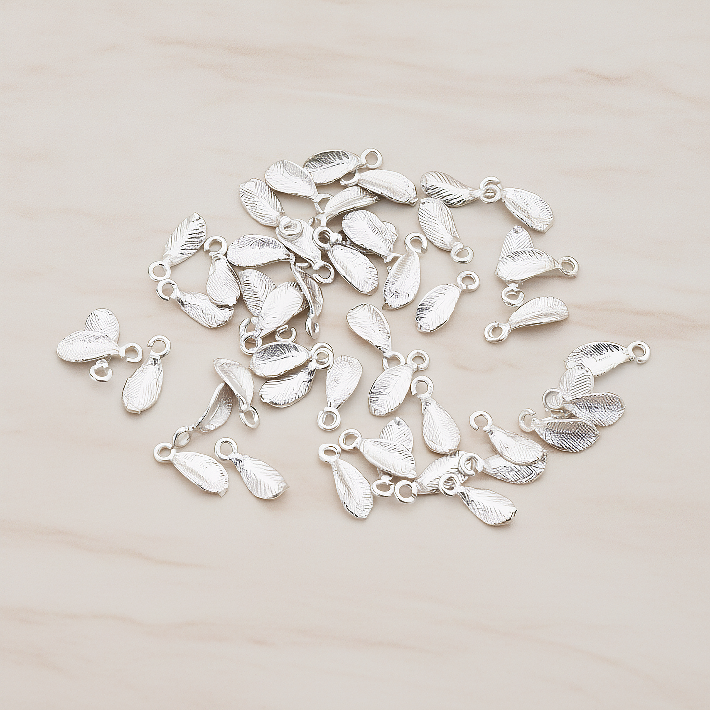 Tiny Leaf Charm Pendant, 8 Pc on warm marble background (PD.426)