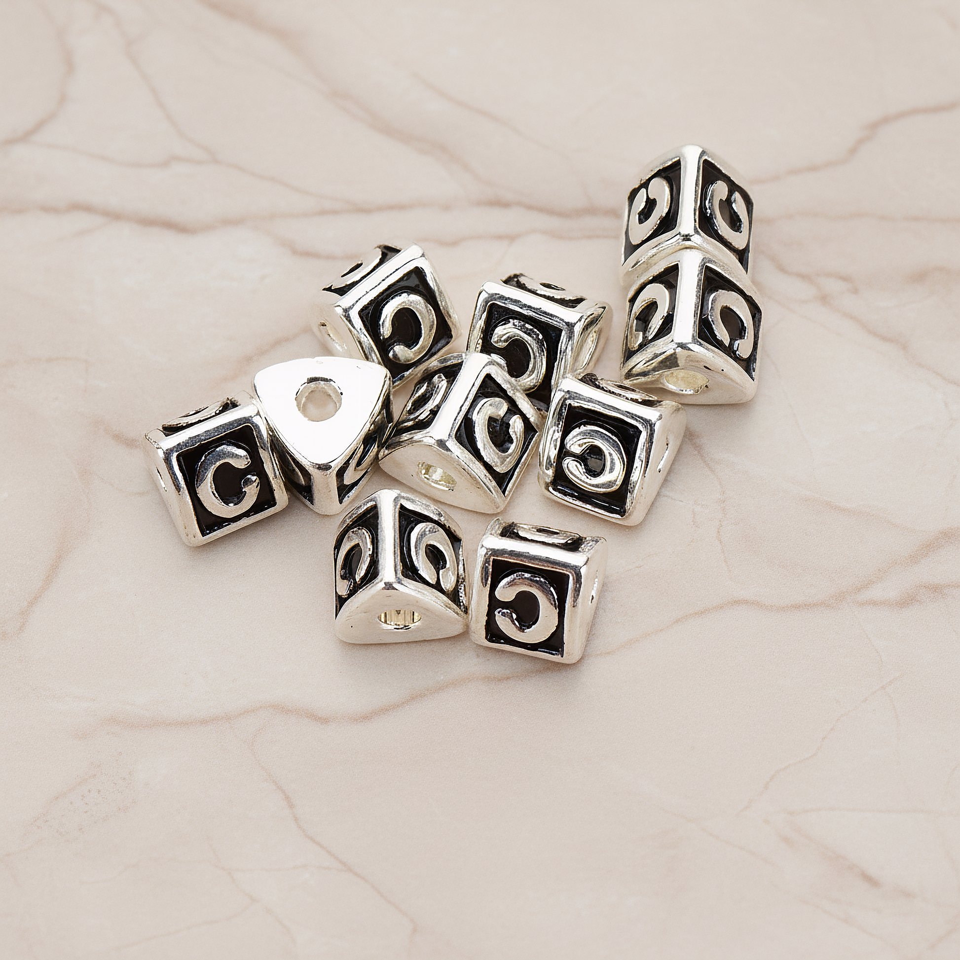 Triangle Cube Initial Metal Bead, 2 Pc on warm marble background (PD.1136)