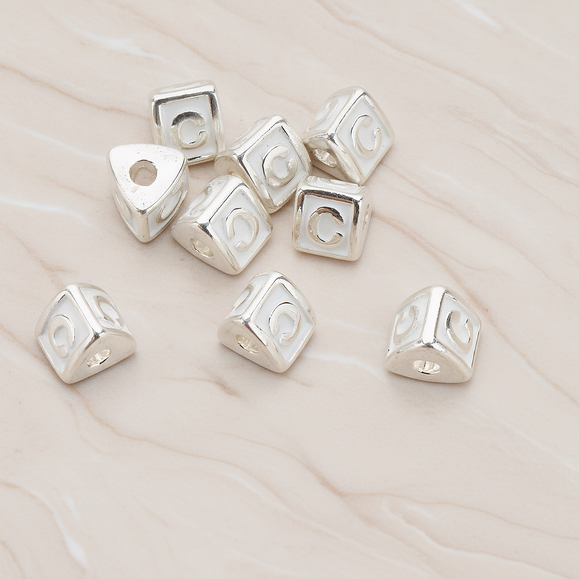 Triangle Cube Initial Metal Bead, 2 Pc on warm marble background (PD.1136)
