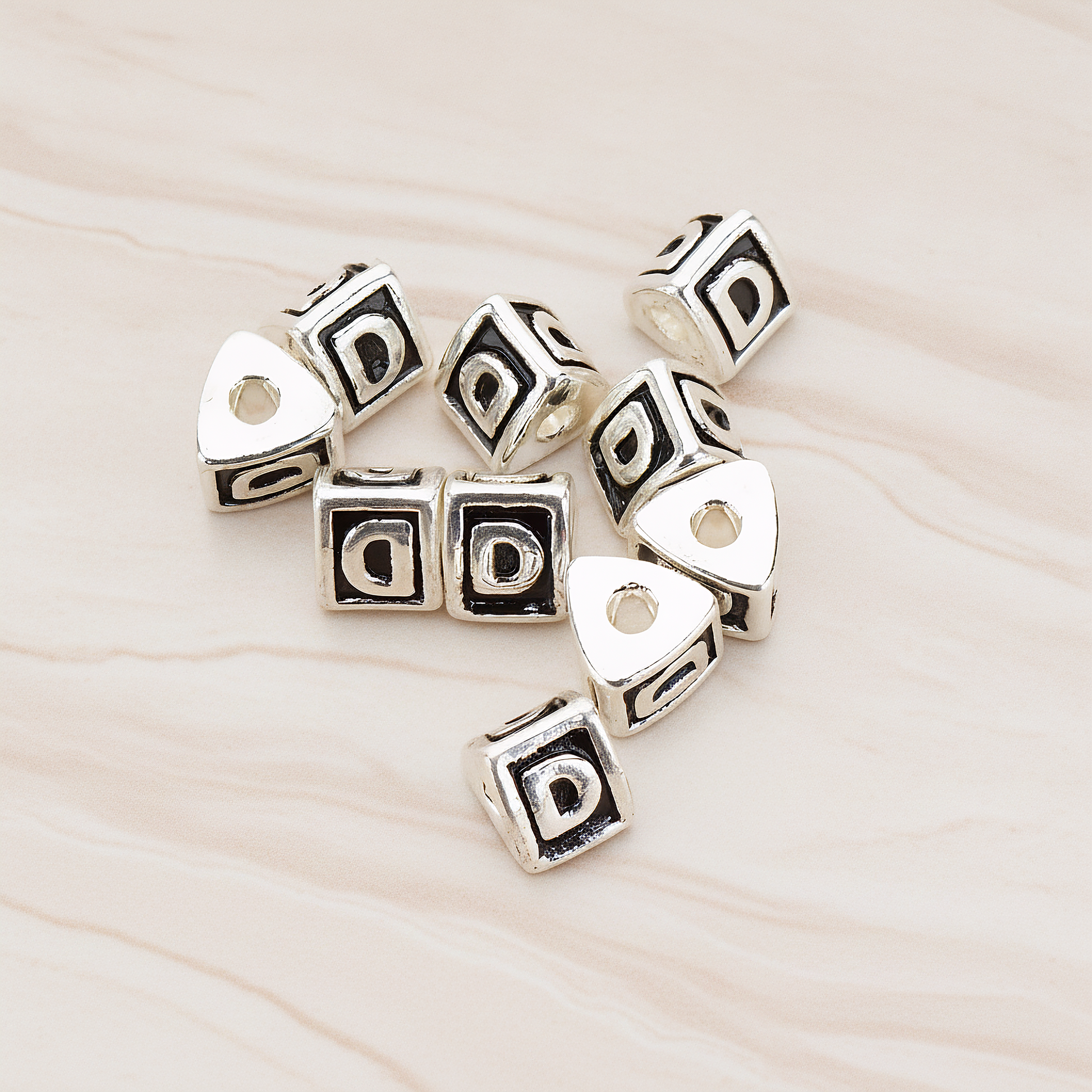 Triangle Cube Initial Metal Bead, 2 Pc on warm marble background (PD.1136)