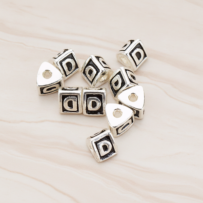 Triangle Cube Initial Metal Bead, 2 Pc on warm marble background (PD.1136)