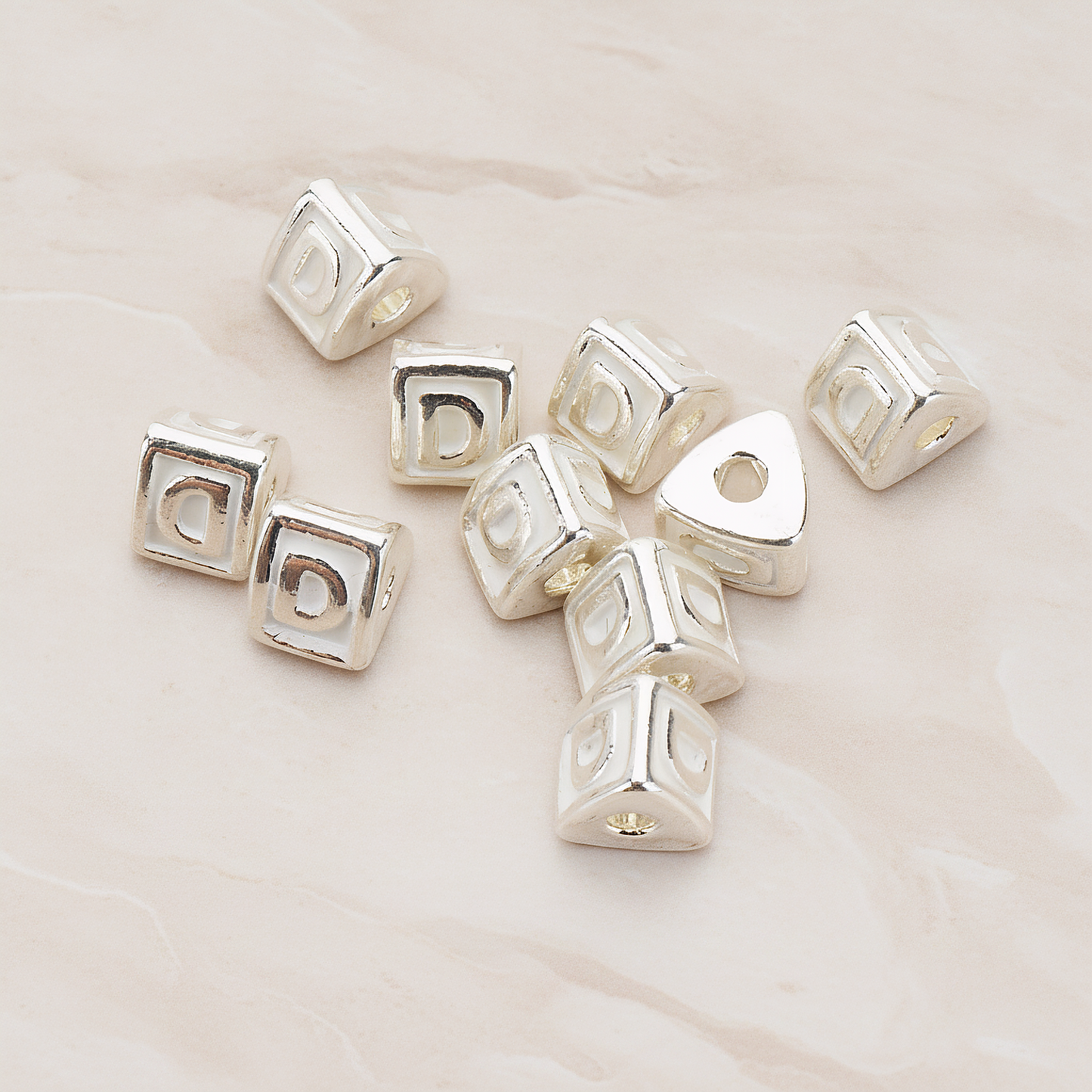 Triangle Cube Initial Metal Bead, 2 Pc on warm marble background (PD.1136)