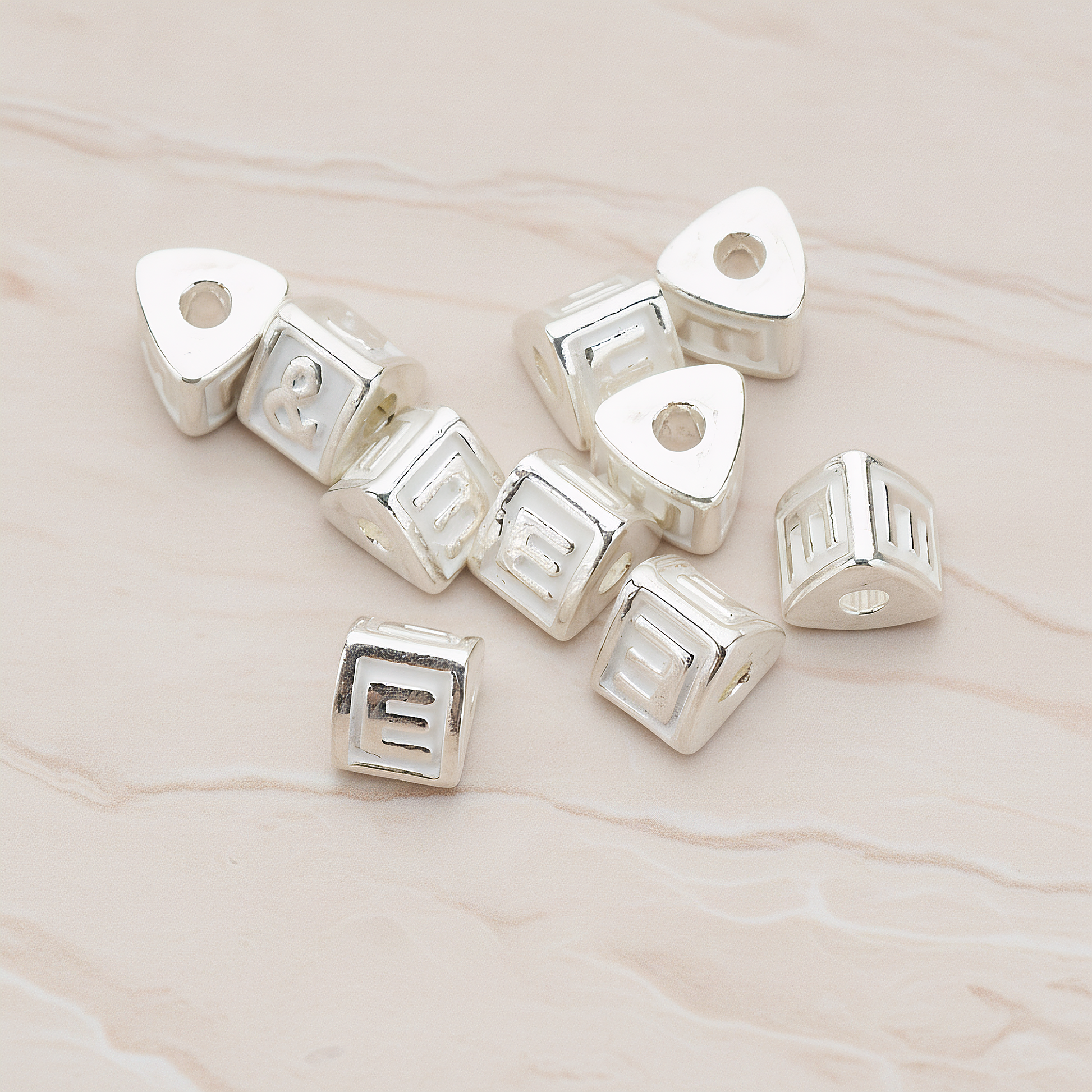 Triangle Cube Initial Metal Bead, 2 Pc on warm marble background (PD.1136)
