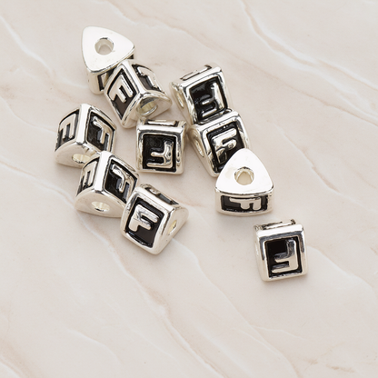 Triangle Cube Initial Metal Bead, 2 Pc on warm marble background (PD.1136)