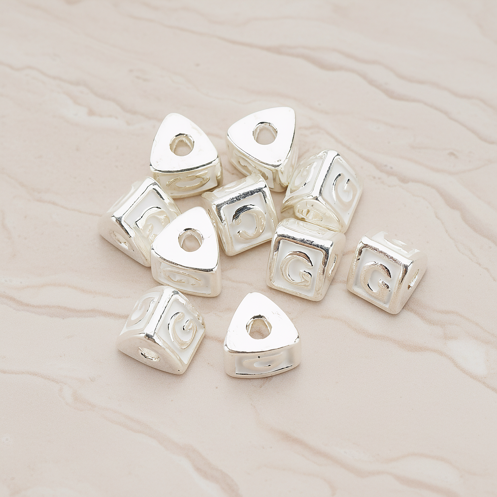 Triangle Cube Initial Metal Bead, 2 Pc on warm marble background (PD.1136)