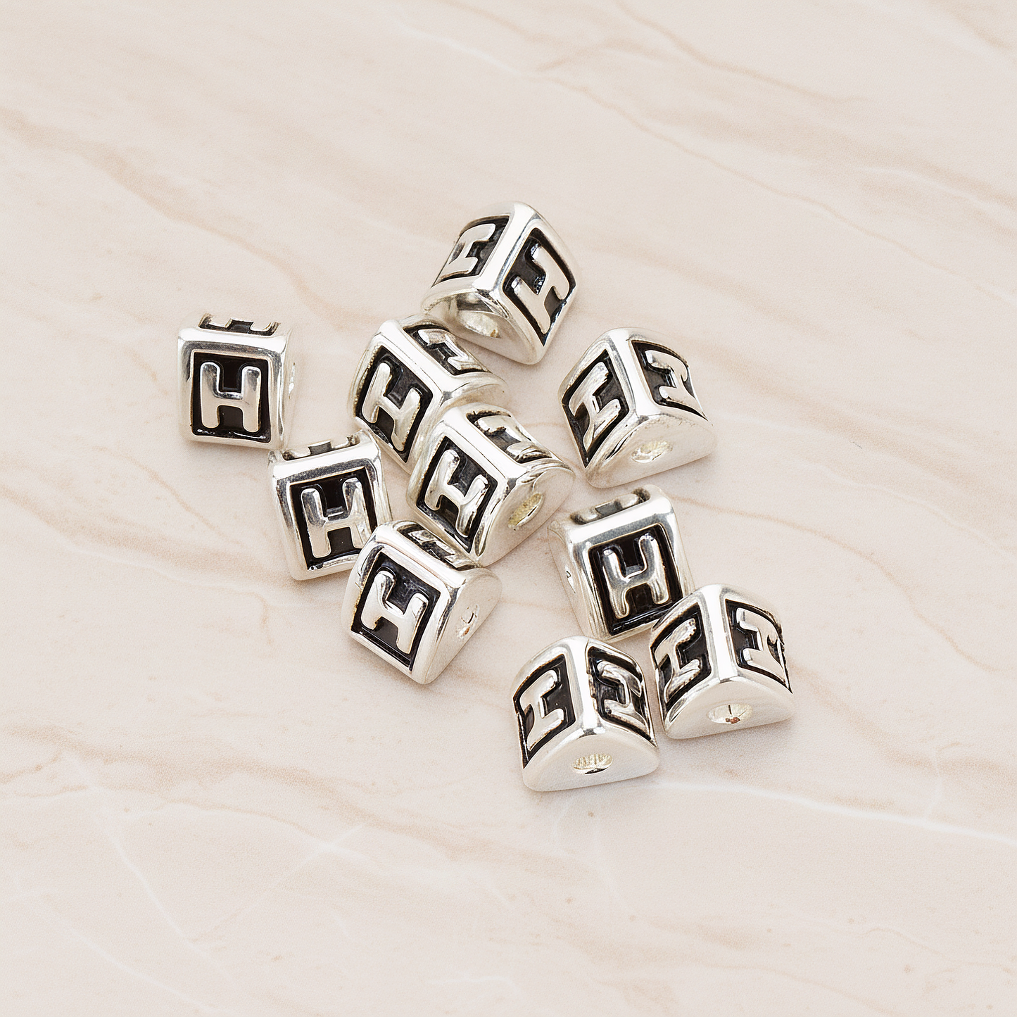 Triangle Cube Initial Metal Bead, 2 Pc on warm marble background (PD.1136)