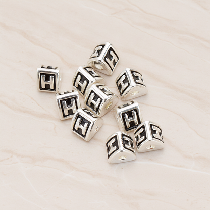 Triangle Cube Initial Metal Bead, 2 Pc on warm marble background (PD.1136)