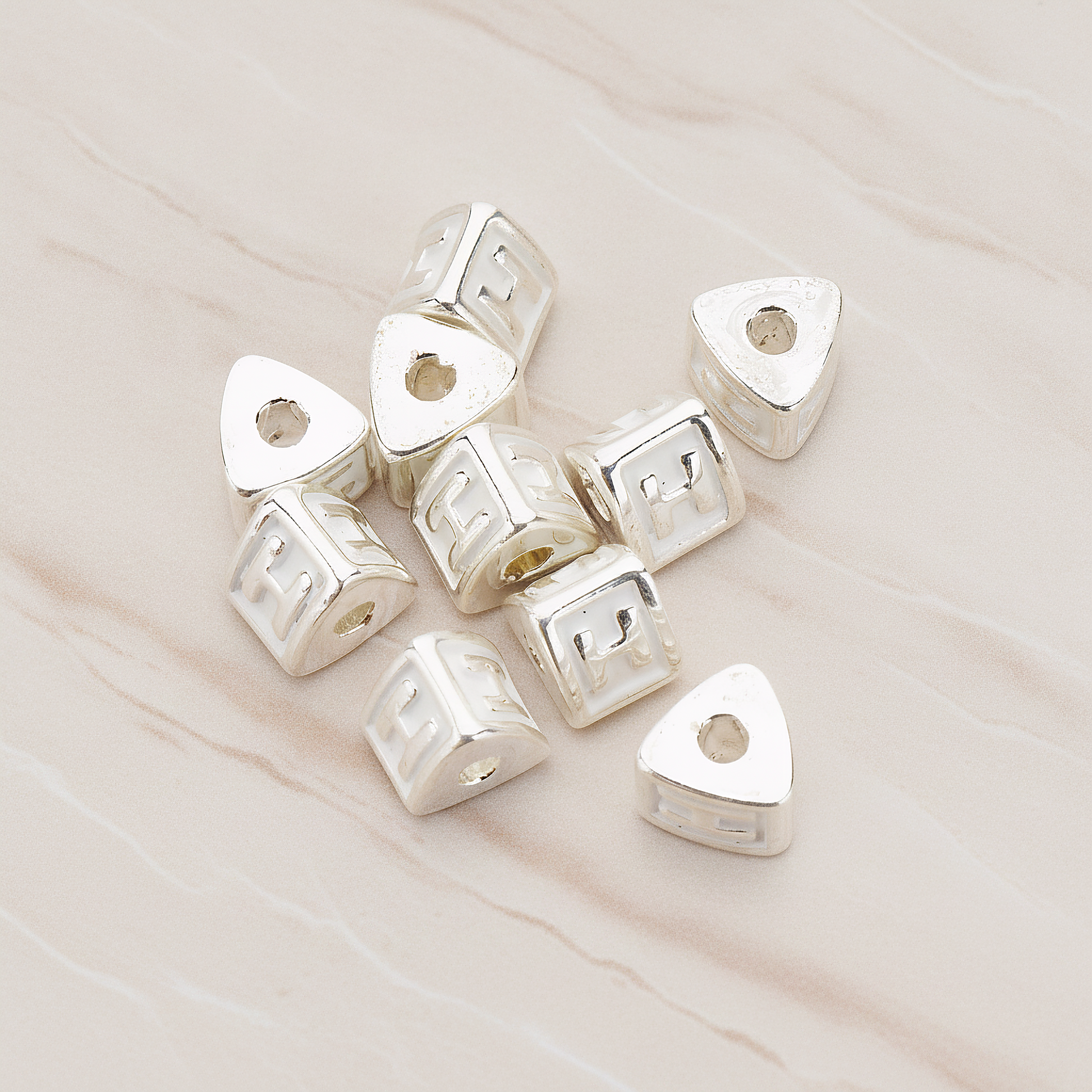 Triangle Cube Initial Metal Bead, 2 Pc on warm marble background (PD.1136)