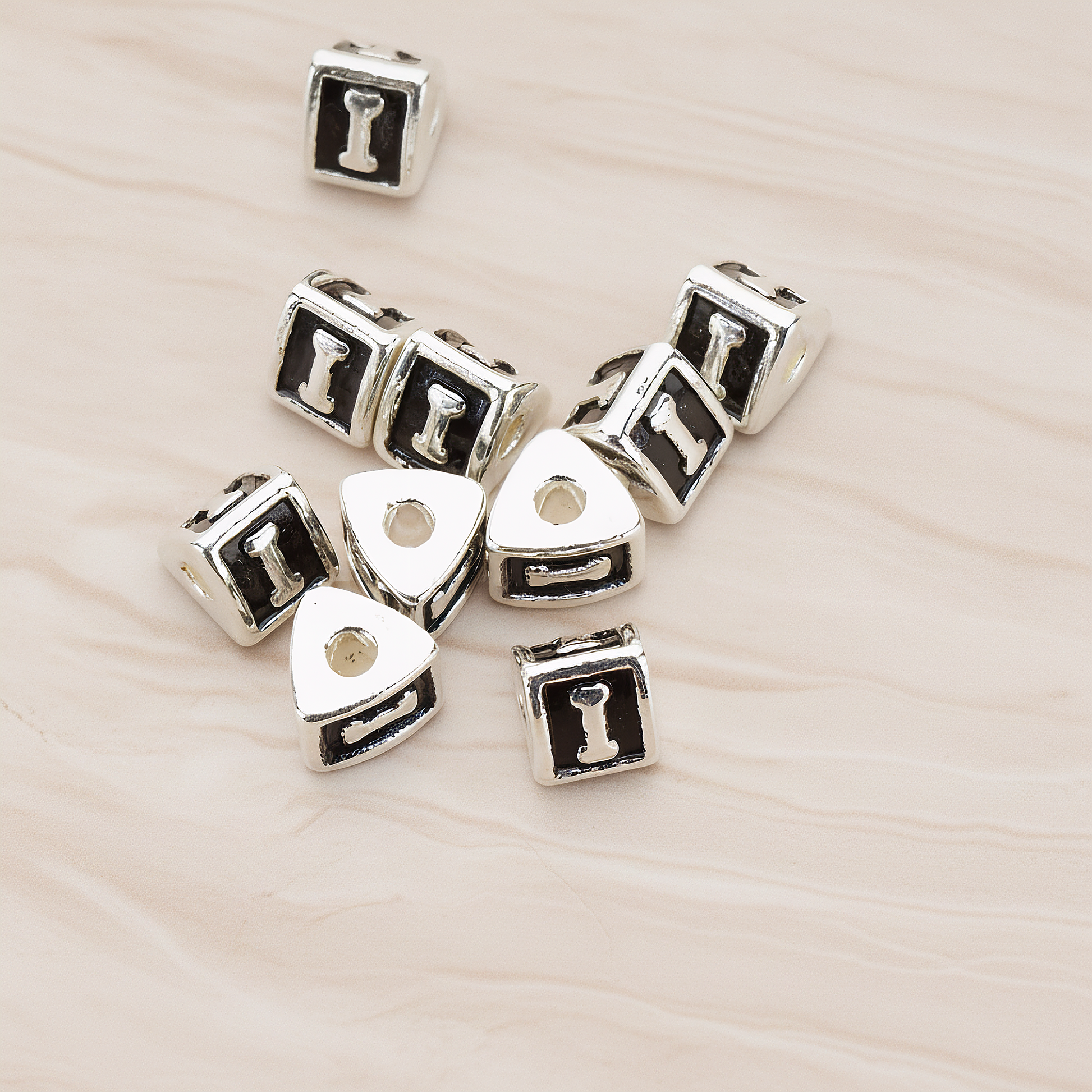 Triangle Cube Initial Metal Bead, 2 Pc on warm marble background (PD.1136)