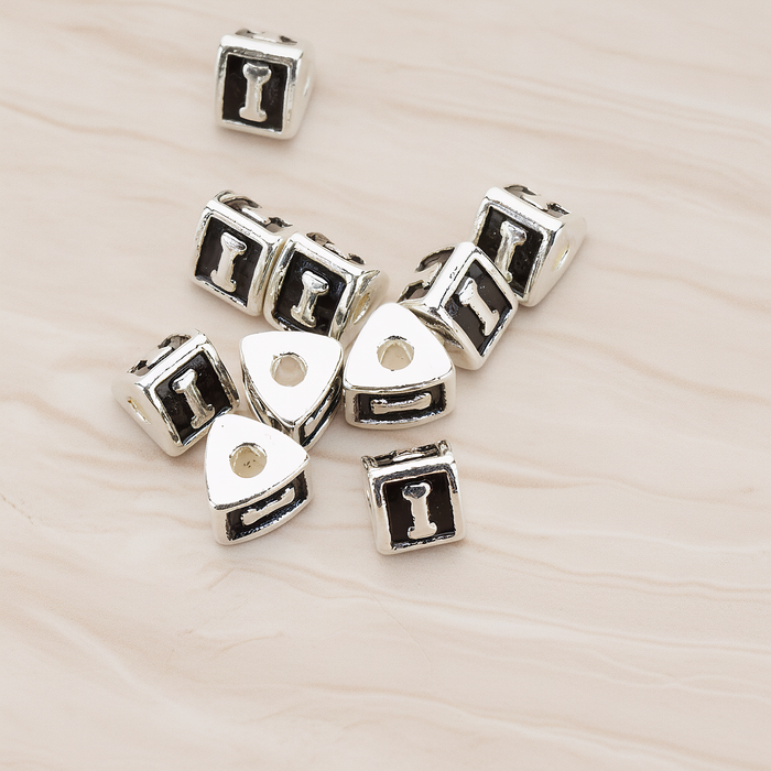Triangle Cube Initial Metal Bead, 2 Pc on warm marble background (PD.1136)