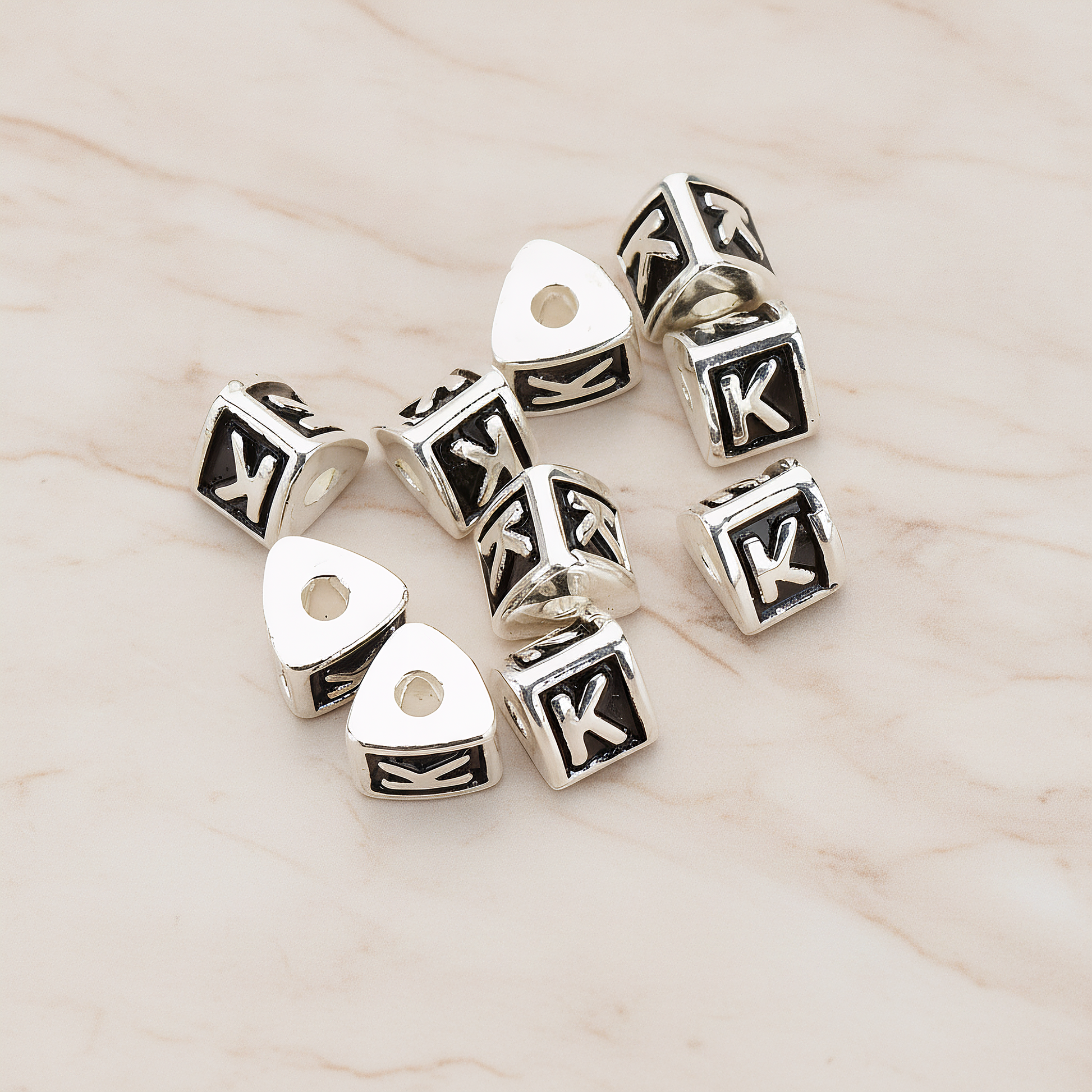 Triangle Cube Initial Metal Bead, 2 Pc on warm marble background (PD.1136)