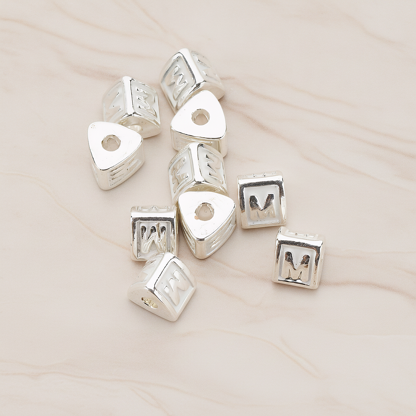 Triangle Cube Initial Metal Bead, 2 Pc on warm marble background (PD.1136)