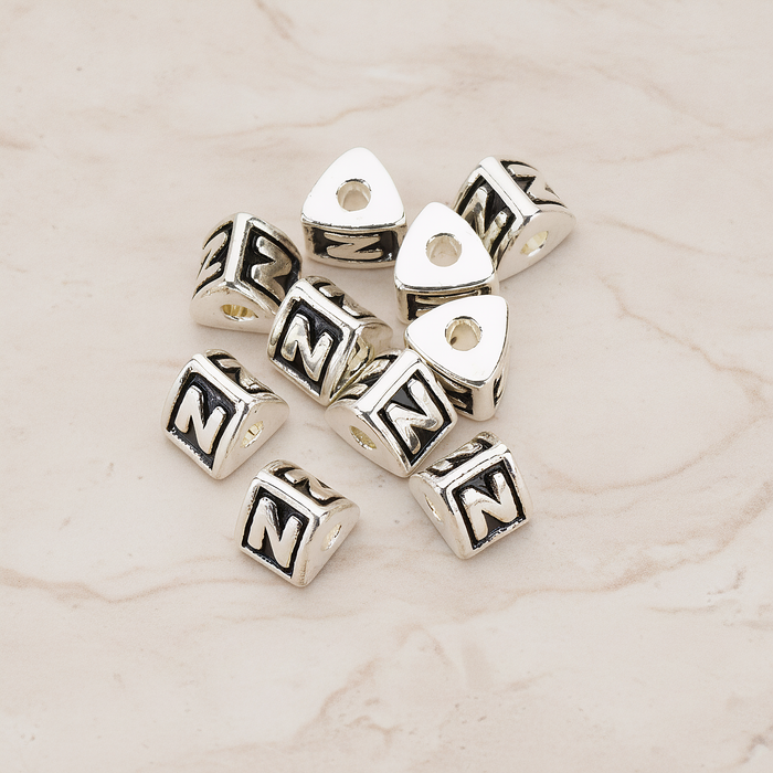 Triangle Cube Initial Metal Bead, 2 Pc on warm marble background (PD.1136)