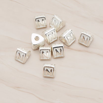 Triangle Cube Initial Metal Bead, 2 Pc on warm marble background (PD.1136)