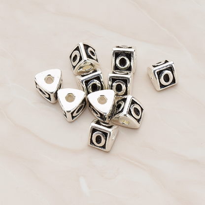 Triangle Cube Initial Metal Bead, 2 Pc on warm marble background (PD.1136)