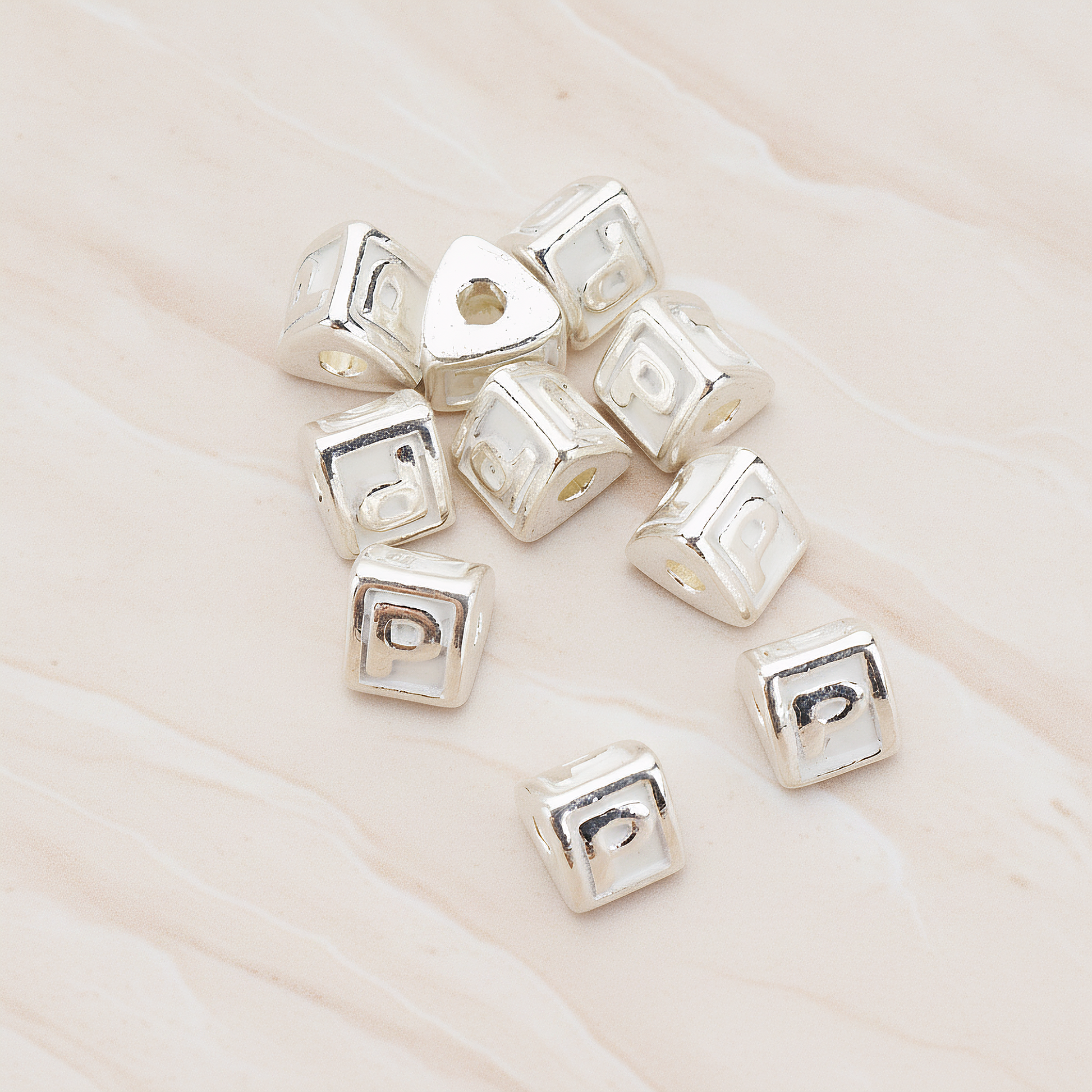 Triangle Cube Initial Metal Bead, 2 Pc on warm marble background (PD.1136)