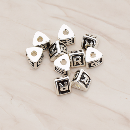 Triangle Cube Initial Metal Bead, 2 Pc on warm marble background (PD.1136)