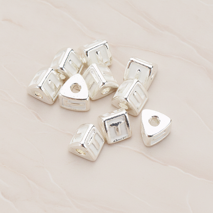 Triangle Cube Initial Metal Bead, 2 Pc on warm marble background (PD.1136)