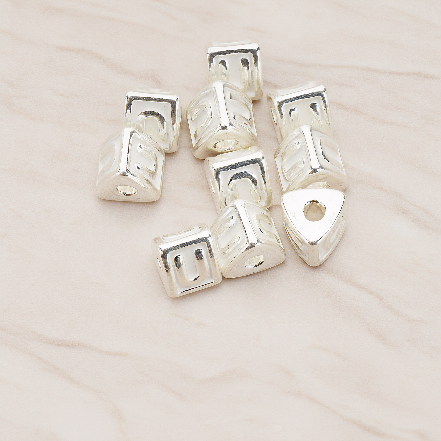 Triangle Cube Initial Metal Bead, 2 Pc on warm marble background (PD.1136)