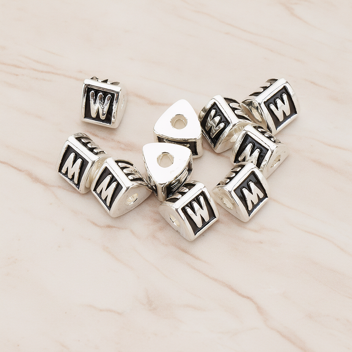 Triangle Cube Initial Metal Bead, 2 Pc on warm marble background (PD.1136)