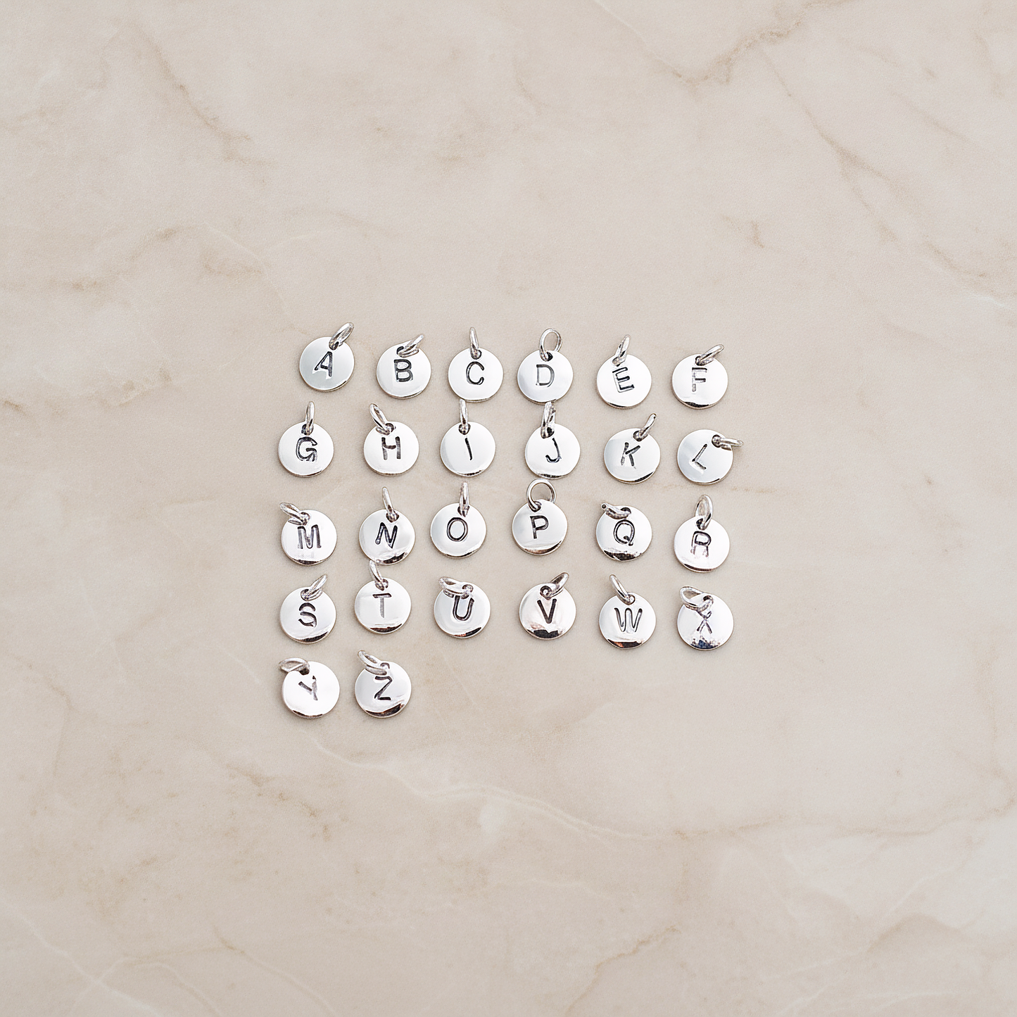 925 Silver Round Initial Stamped with Jumpring on Pendant, 1 Pc on warm marble background (PD.078)