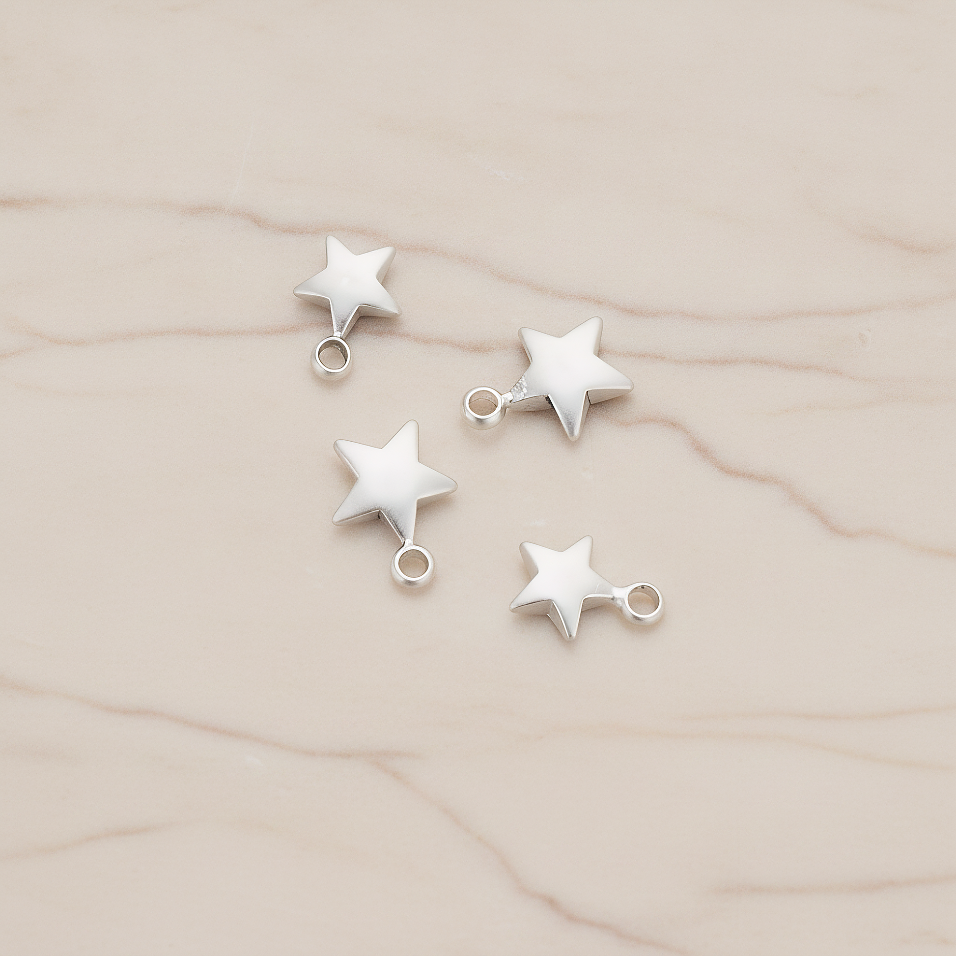 Mini 3D Star Pendant, 4 Pc on warm marble background (PD.1211)