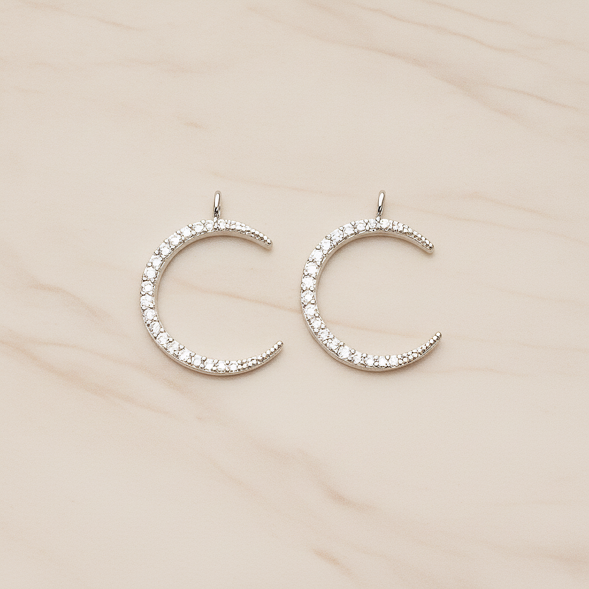 Cubic Zirconia Setting Thin Crescent Moon Pendant, 1 Pc on warm marble background (PD.1365)