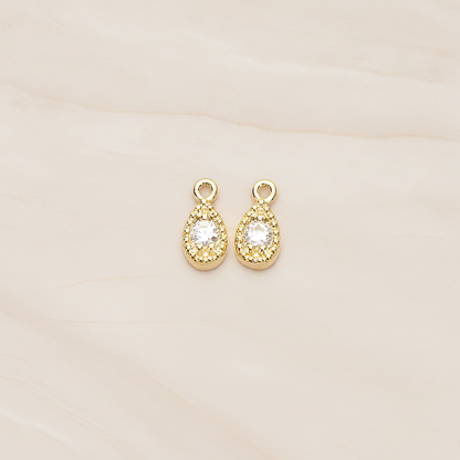 Oval Cubic Setting Textured Frame Mini Teardrop Pendant, 2 Pc on warm marble background (PD.1389)