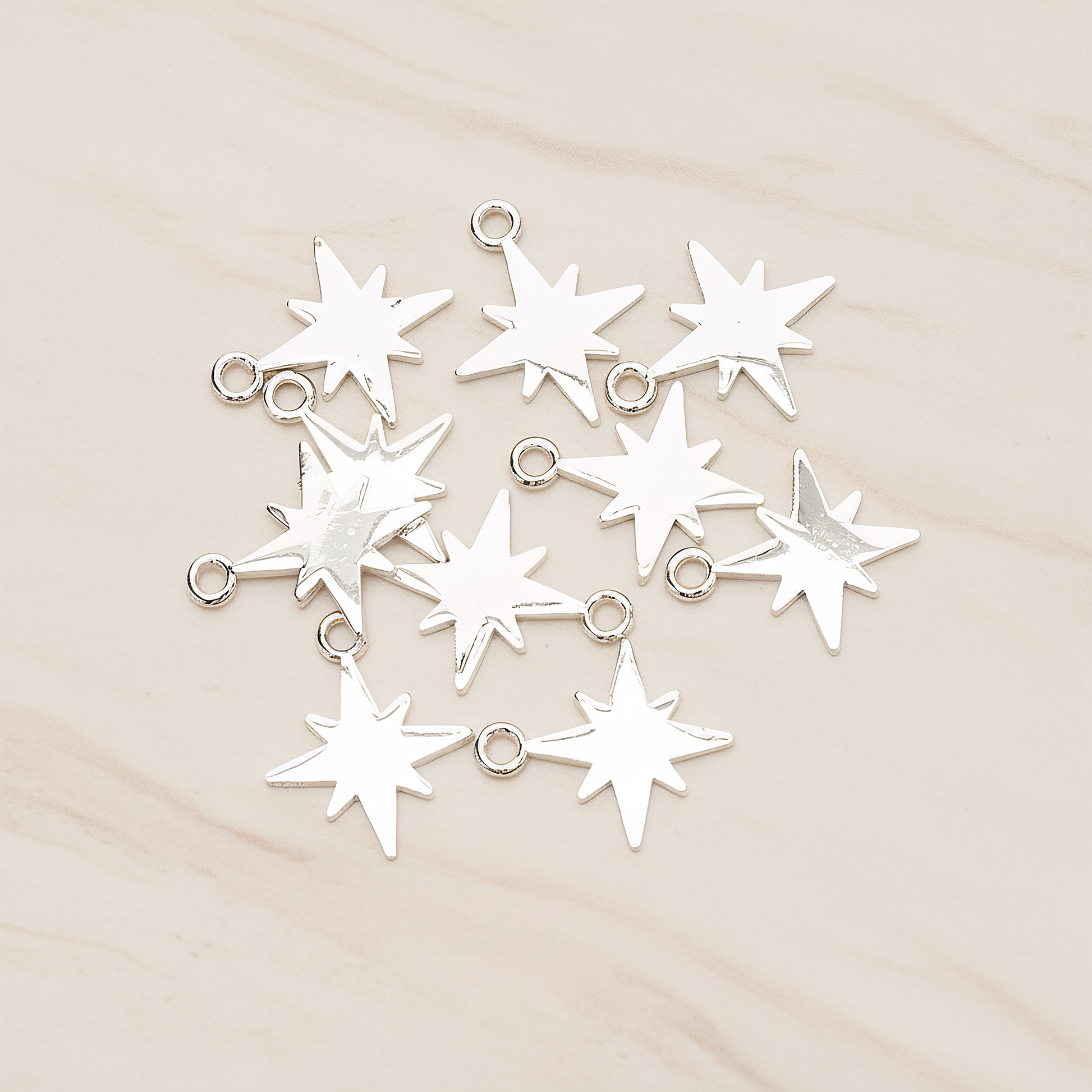 Simple Bright Shinny Star Charm Pendant, 2 Pc on warm marble background (PD.1480)