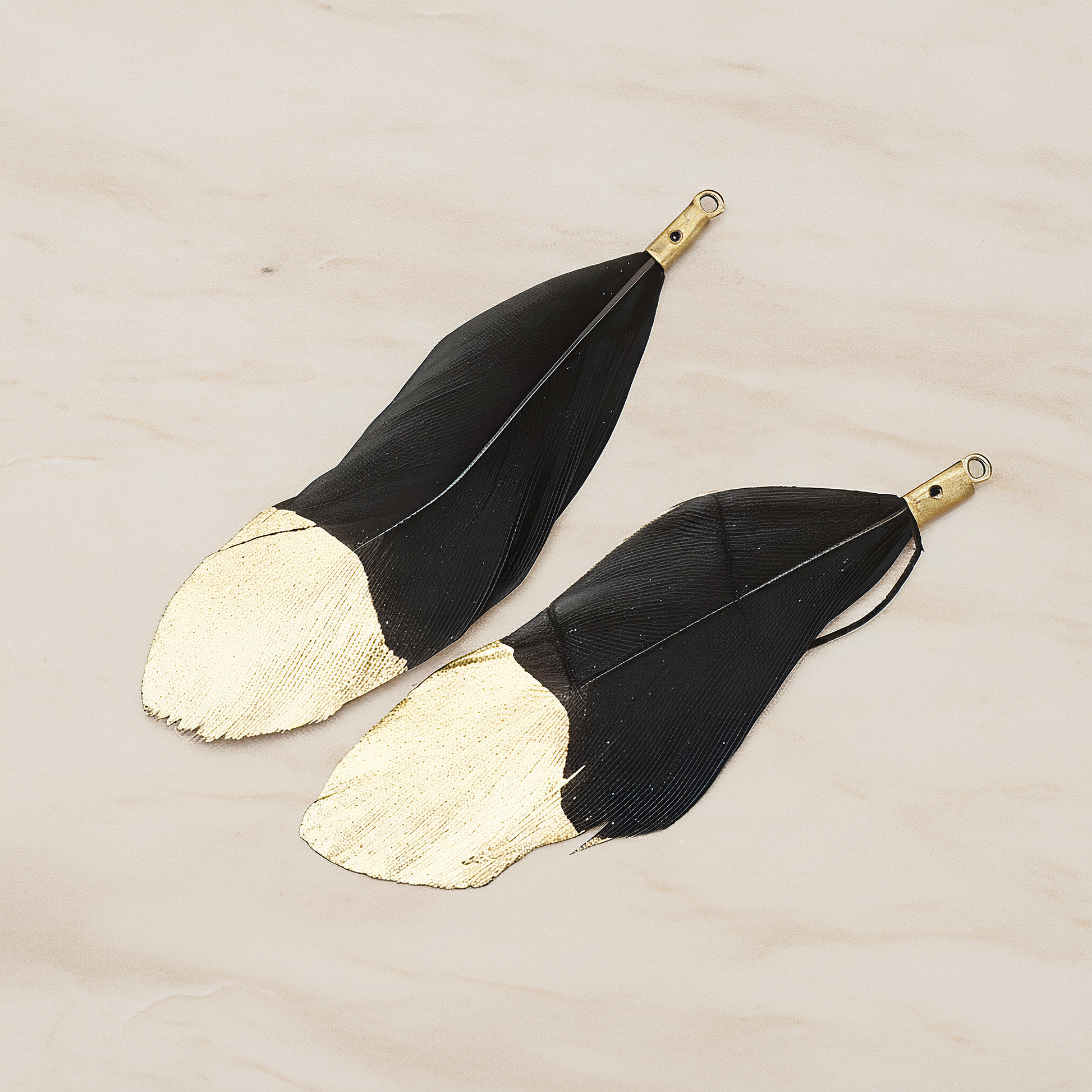 Artificiality Feather Half Dipped in Gold Pendant, 2 Pc on warm marble background (PD.1492-01)