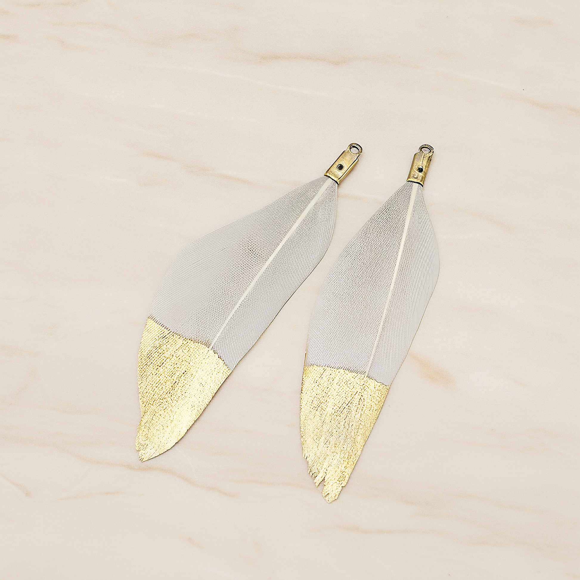 Artificiality Feather Half Dipped in Gold Pendant, 2 Pc on warm marble background (PD.1492-01)