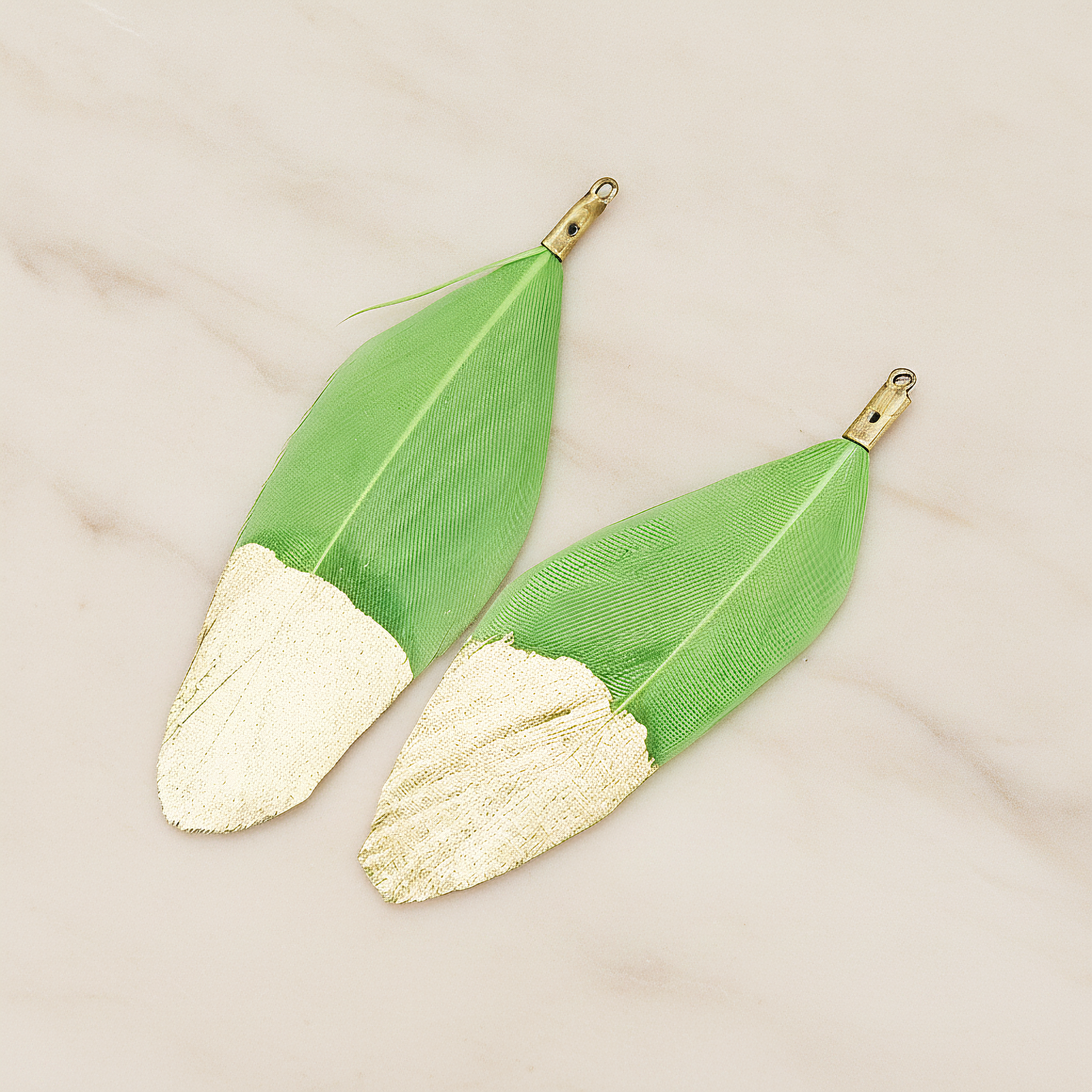 Artificiality Feather Half Dipped in Gold Pendant, 2 Pc on warm marble background (PD.1492-01)