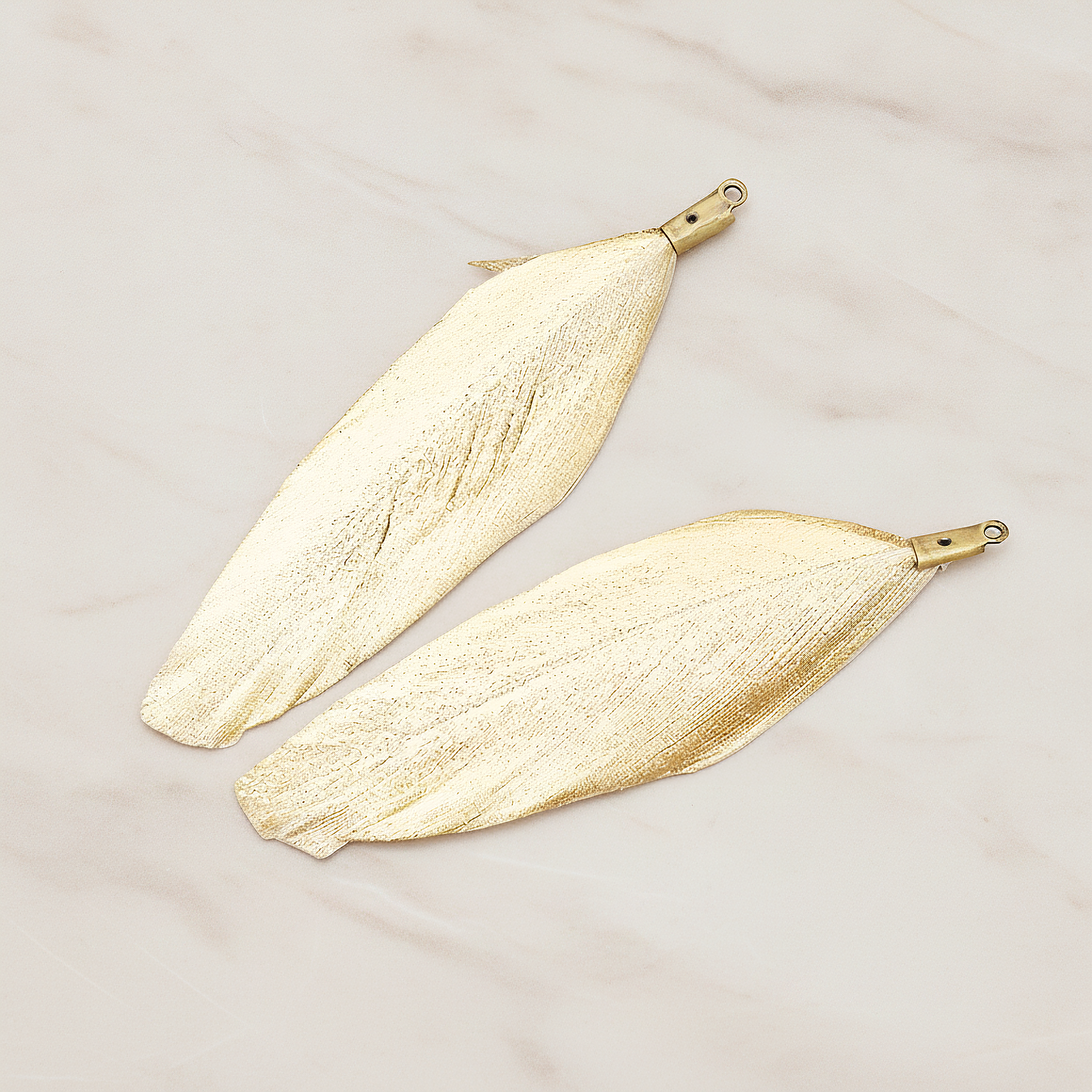 Artificiality Feather Charm Pendant, 2 Pc on warm marble background (PD.1492-04)