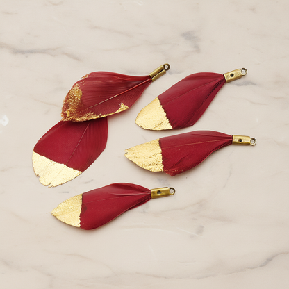 Small Artificiality Feather Half Dipped in Gold Colored Pendant, 2 Pc on warm marble background (PD.1492-05)