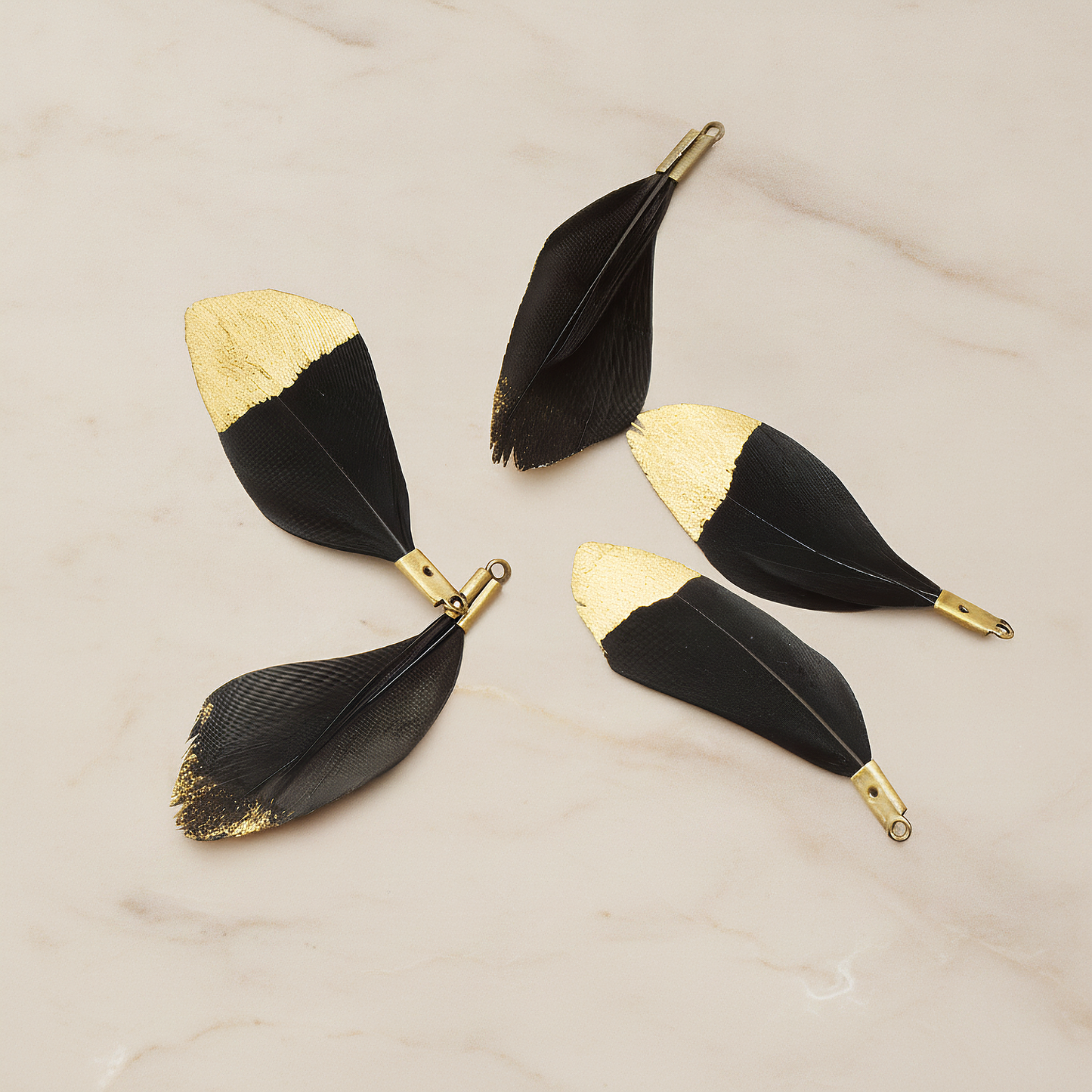 Small Artificiality Feather Half Dipped in Gold Colored Pendant, 2 Pc on warm marble background (PD.1492-05)