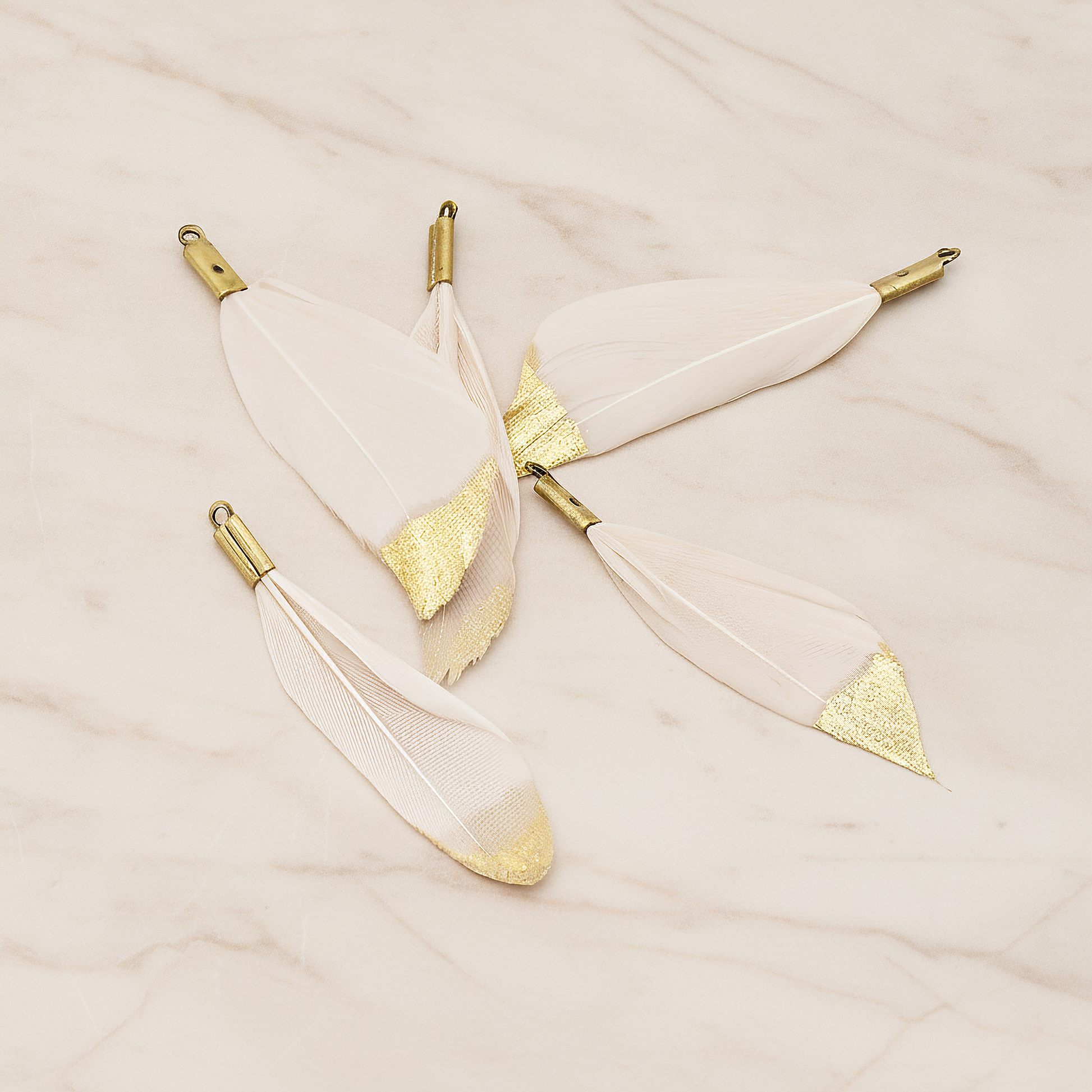 Small Artificiality Feather Half Dipped in Gold Colored Pendant, 2 Pc on warm marble background (PD.1492-05)