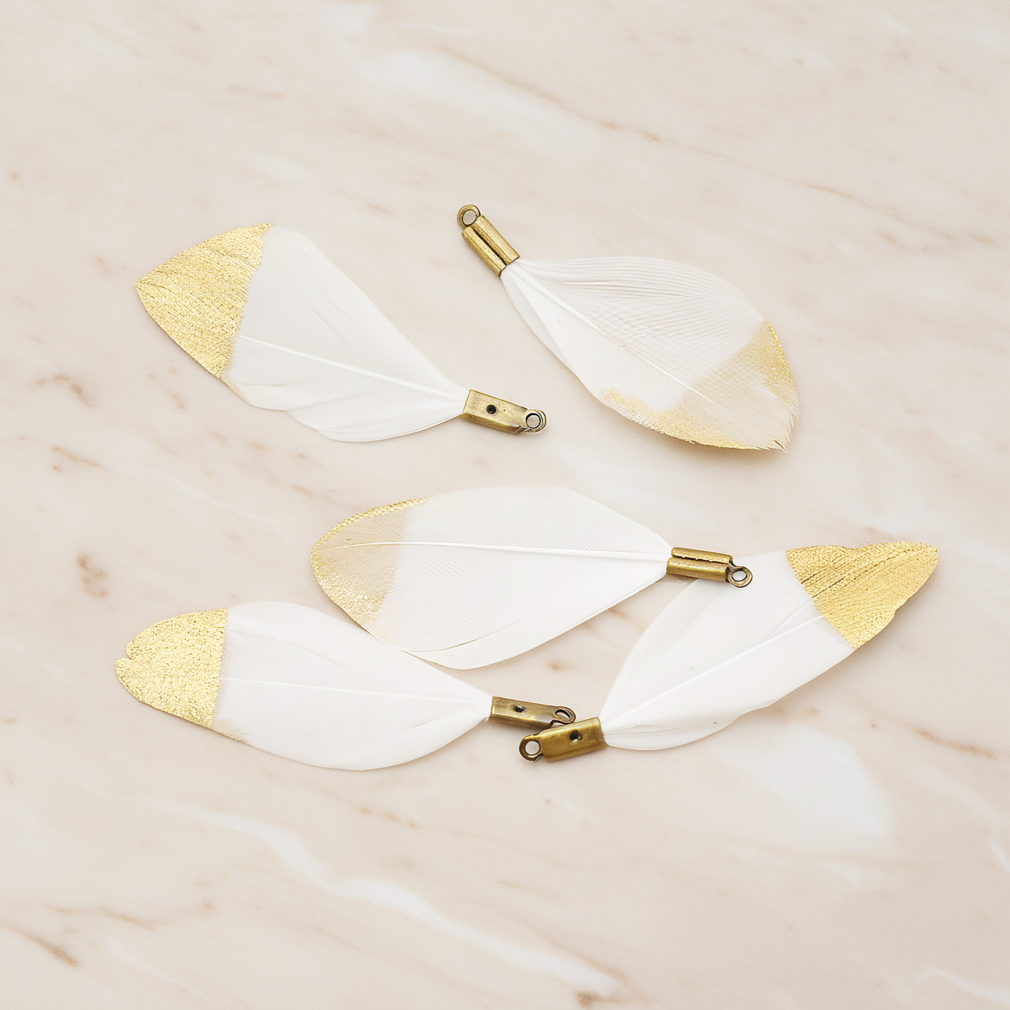 Small Artificiality Feather Half Dipped in Gold Colored Pendant, 2 Pc on warm marble background (PD.1492-05)