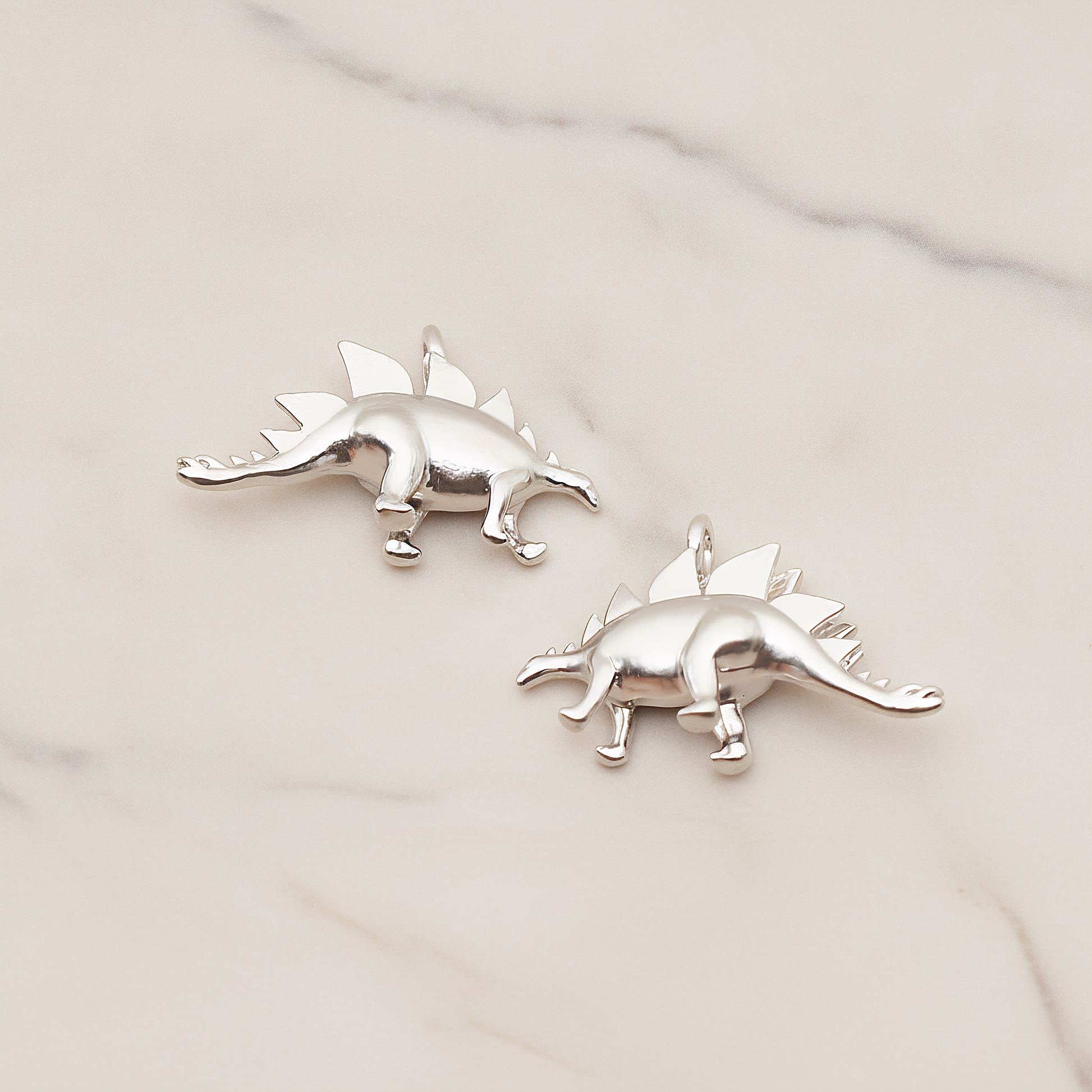 Stegosaurus, Dinosaur Pendant, 2 Pc on warm marble background (PD.1797)