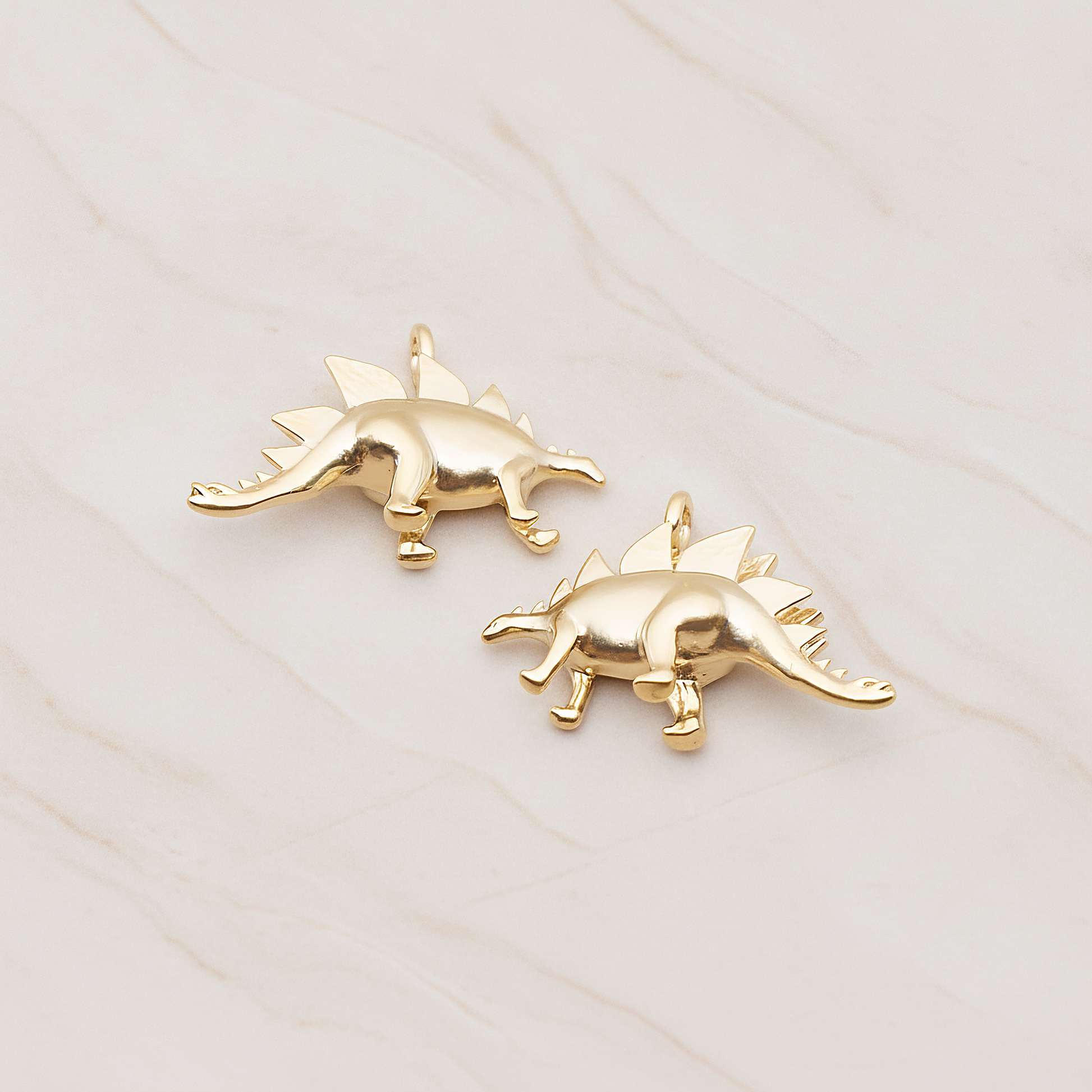Stegosaurus, Dinosaur Pendant, 2 Pc on warm marble background (PD.1797)