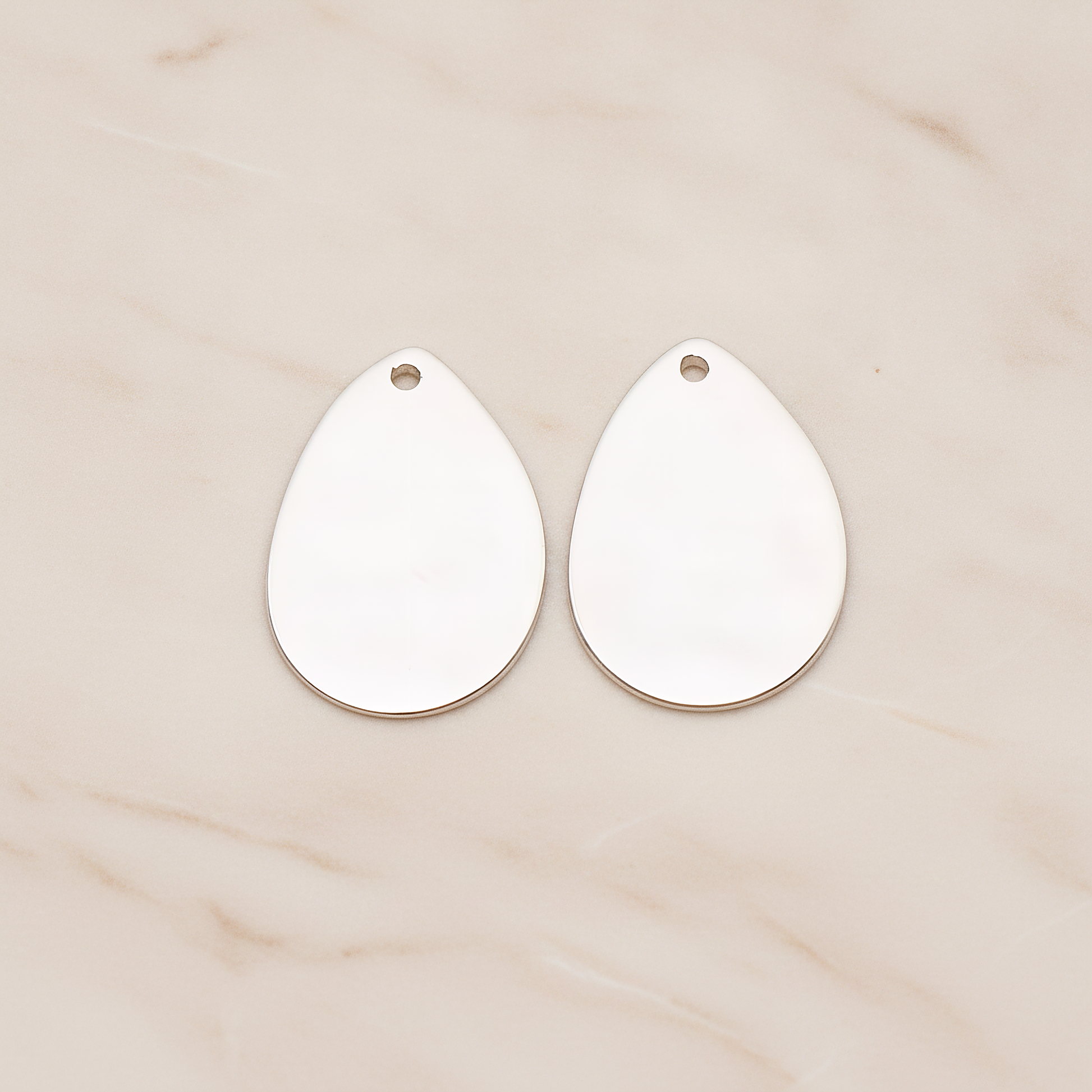 Small Teardrop Stamped Hammered Pendant, 2 Pc on warm marble background (PD.1826-01)