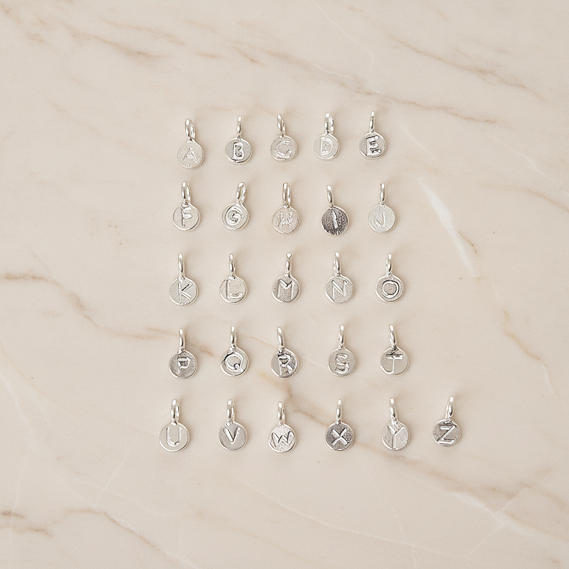 925 Silver Small Round Initials Pendant, 1 Pc on warm marble background (PD.1940)