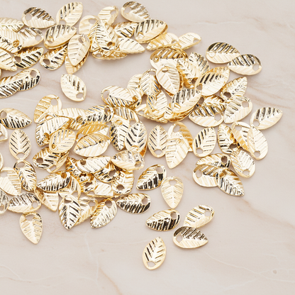 Half Fold Tiny Leaf Charm, 20 Pc on warm marble background (PD.222)